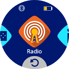 A circular screen showing the Radio tile selected in the center of the VEX AIM interface. The tile has a white antenna icon with signal waves on an orange diamond and the label Radio below it. The top right corner shows a low yellow battery icon.