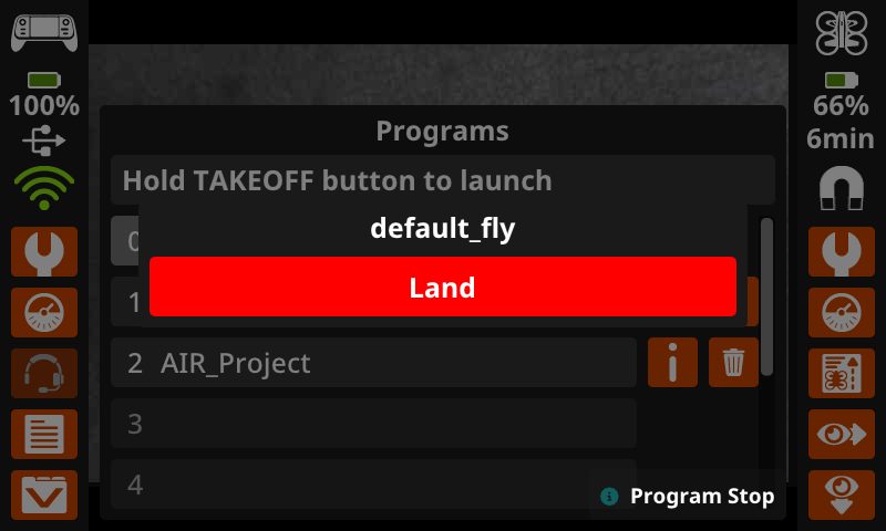 The same image as the one previous, now with a prompt reading default fly with a red land button displaying prominently in the center of the screen, overlaying the Programs menu.