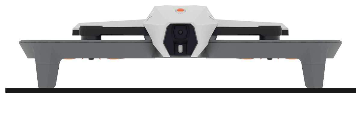 A drone sits on a level surface, with the nose facing you head-on.