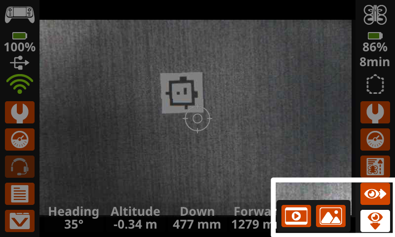 La pantalla del controlador muestra una vista de cámara hacia abajo en la pantalla principal, con los botones Eye en la esquina inferior derecha resaltados, mostrando las opciones para capturar imágenes desde el sensor de visión hacia abajo.