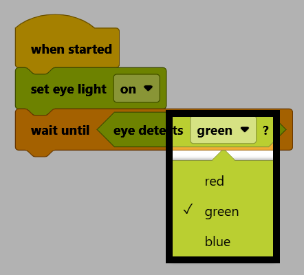 Captura de pantalla del proyecto, con el menú desplegable del bloque de color de detección ocular abierto, mostrando las opciones rojo, verde y azul, y el verde seleccionado.