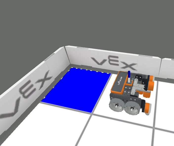 Una esquina de un entorno de juego de realidad virtual, donde se ve el cuadrado de la cuadrícula de la esquina relleno de azul, con el robot de realidad virtual en el cuadrado contiguo.