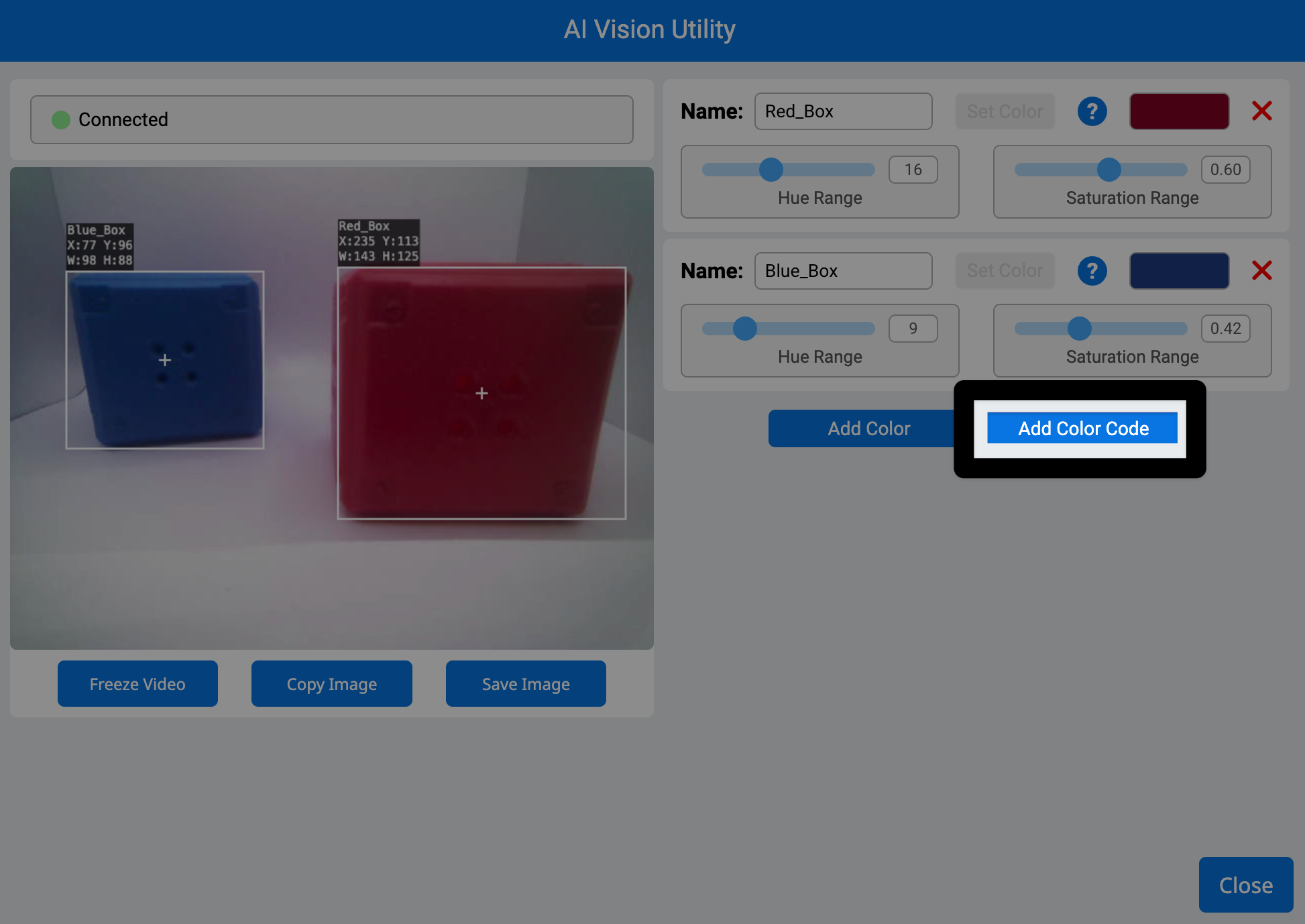 这是 VEXcode AIM 中 AI 视觉工具的屏幕截图。左侧显示了机器人摄像头拍摄的画面，画面中包含一个蓝色立方体和一个红色立方体。右侧高亮显示了“添加颜色代码”按钮，该按钮位于“添加颜色”按钮右侧中间位置。